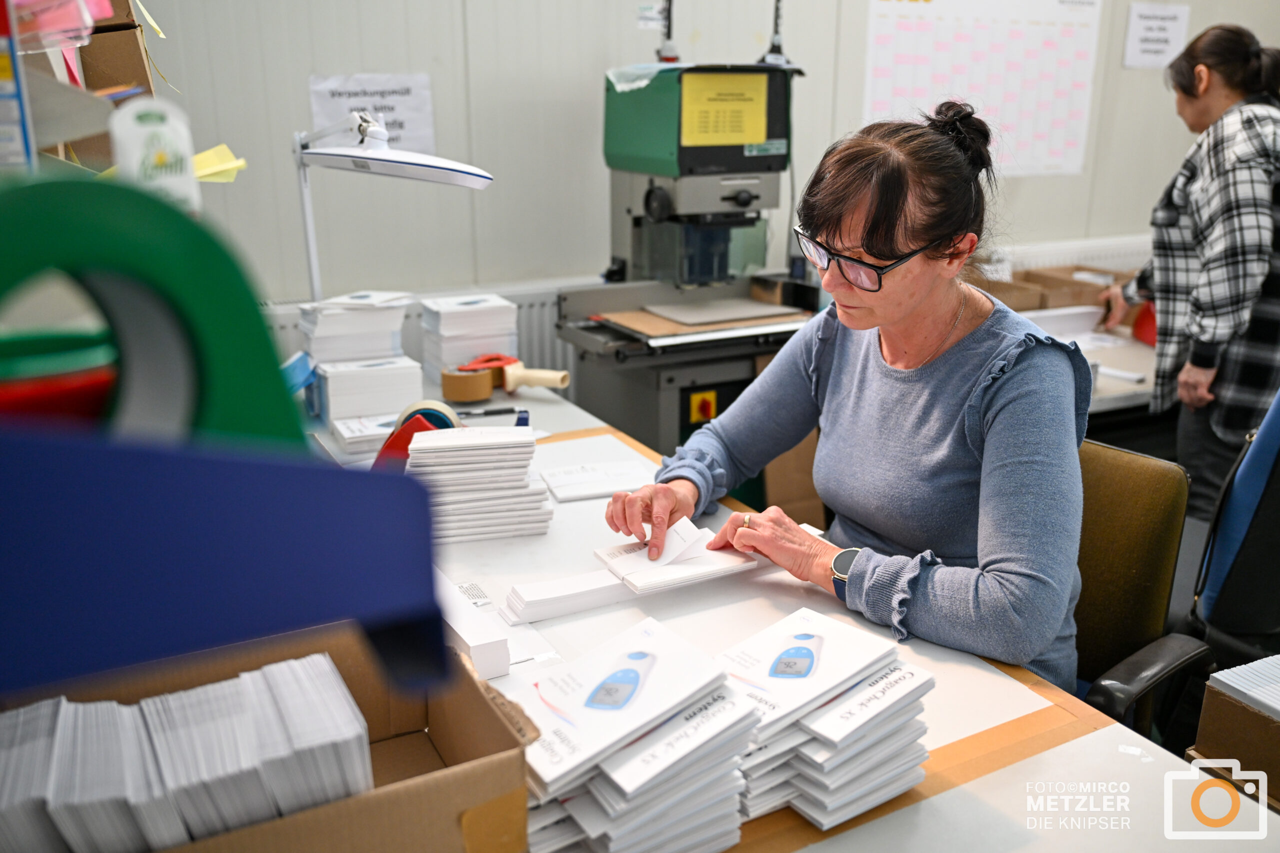 Two people discussing and choosing color palettes for interior design projects.